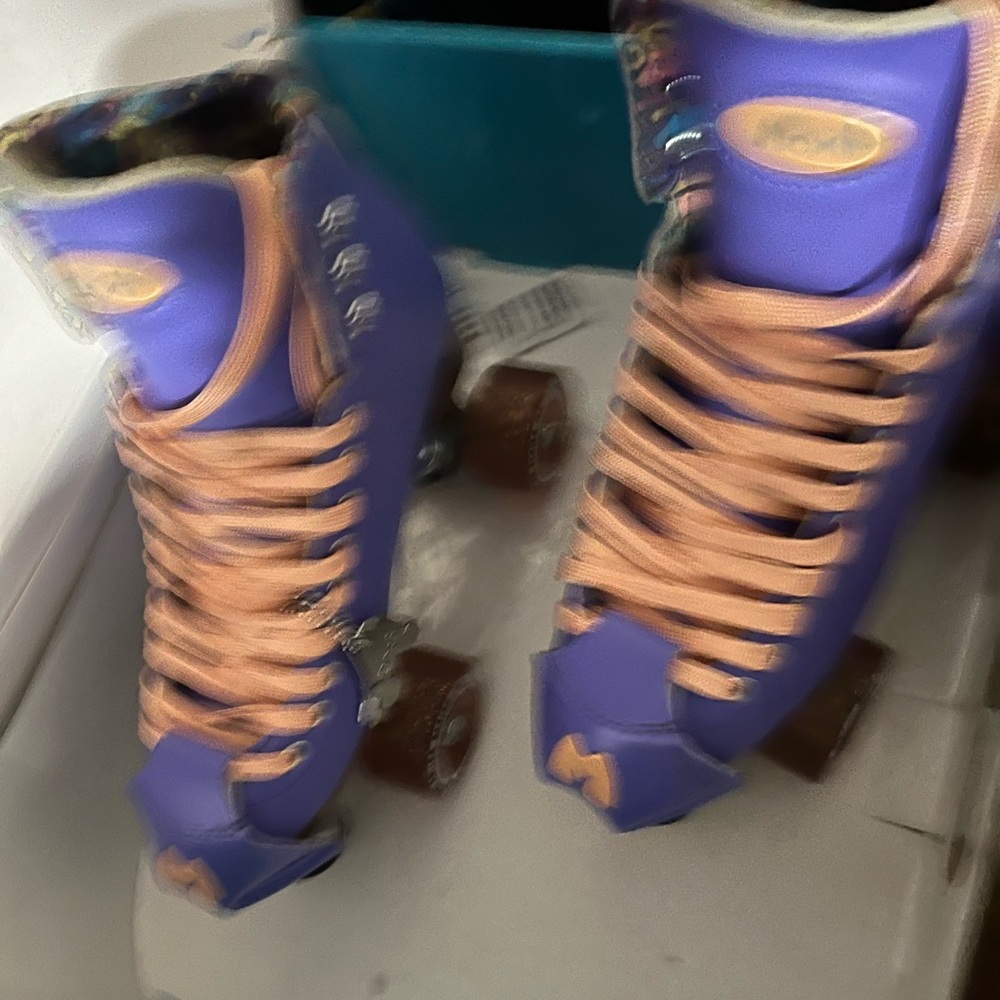 MOXI BEACH BUNNY PERIWINKLE SKATES.Vibrant Purple Roller Skates with Peach Laces